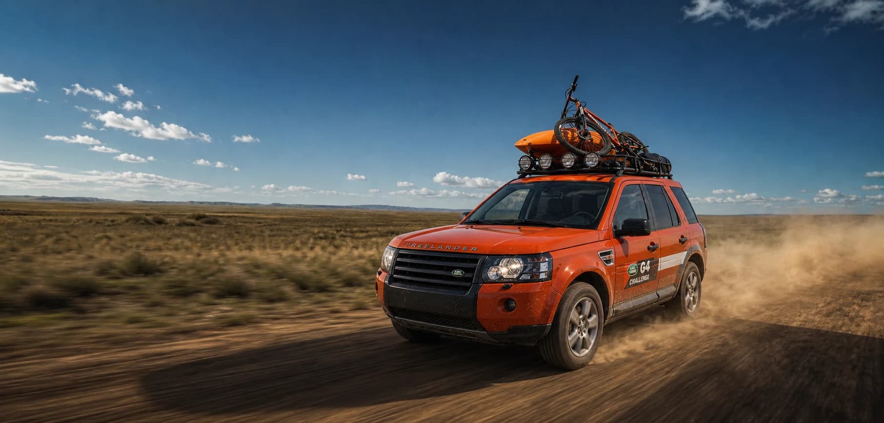 G4 Challenge Freelander 2 carrying a kayak and mountain bike across open steppe